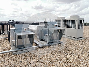 View of air ventilation ducts, extraction and insufflation, HVAC system, and exterior AC units on the building roof