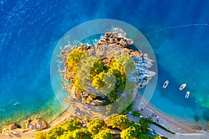 View from the air on the waves and rocks. Sea relaxation and travel. The forest near the sea. Azure water on the sea.