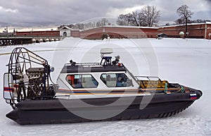 View of the airboat of the search and rescue service of St. Petersburg on the ice against the background of the Peter and Paul