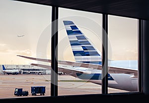 View of airplane fuselage tail with cargo through window at airport
