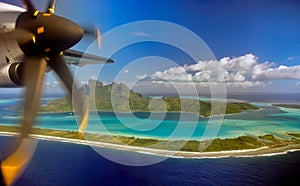 View of airplane propeller and the island of Bora Bora during landing.