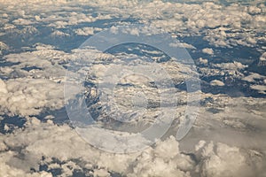 view from airplane window in flight over mountains over Europe