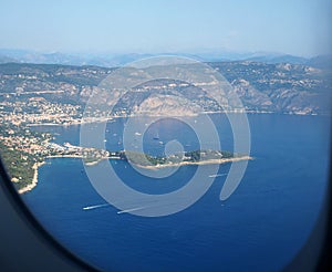 View from the airplane window on the Mediterranean Sea, the mountains of the Alps, French Riviera, Cote d`Azur, Nice, France
