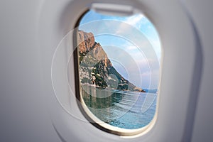 View from airplane window on Omis city in Croatia. Travel and vacation concept.