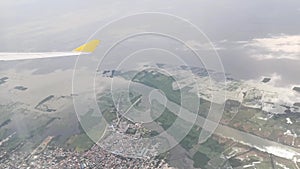 View from the airplane window showing skyline, clouds, beautiful forest, ocean, ships, mountains, islands and buildings