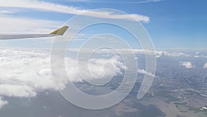 View from the airplane window showing skyline, clouds, beautiful forest, ocean, ships, mountains, islands, houses and buildings