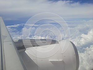 view from airplane window,airplane in the sky, wing of airplane, flight window view of blue sky.