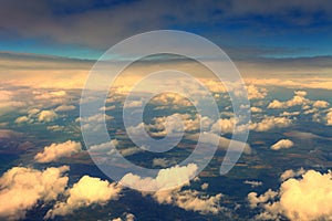 View from airplane window on sunset clouds