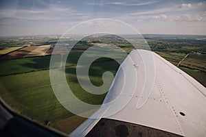 View from the airplane window to green fields