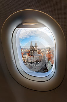 View from an airplane window to the old town and famous Tyn Church of the European city