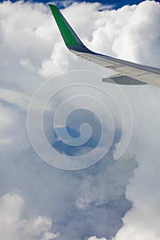 View from the airplane window to the sky in the clouds, vertical orientation