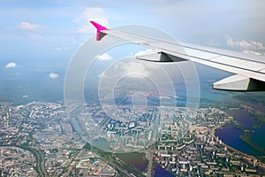 View from airplane of the wing and city beneath