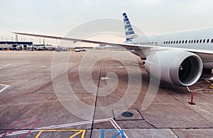 View of airplane wing and engine on tarmac at airport