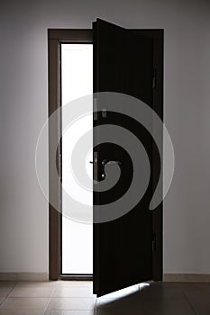 View of ajar wooden door