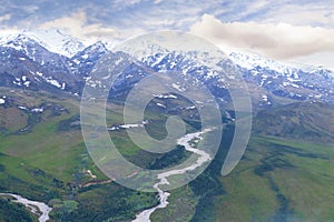 View of Alaskan Mountain Range and River in Valley