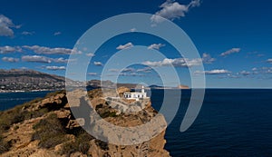 view of the Albir Lighthouse on the rocky promontory in the Serra Gelada Natural Park between Benidorm and Altea