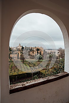 View of the Alhambra through a window in the gardens of the Generalife.