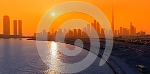 View of all skyscrapers from Dubai Creek sea Bay at golden hour sunset. City life in the UAE concept