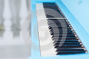 View along a blue piano keyboard