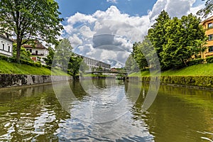 A view along the Ljubljanica River towards the St. Peter\'s Bridge in Ljubljana