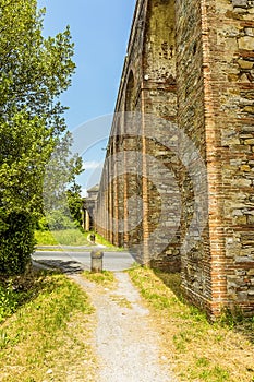 A view along the Nottolini aqueduct crossing a residential road in Lucca Italy