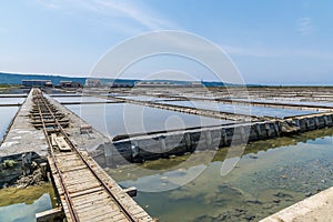 A view along the rail line beside crystallisation pools at the salt pans at Secovlje, near to Piran, Slovenia