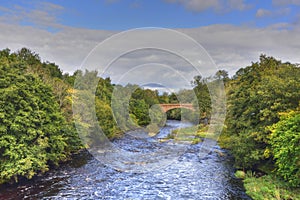 Autumn River Scene with Historic Bridge photo