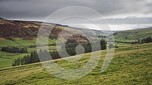 Wharfedale valley with hilltops, green fields, dry stone walls and overcast sky, Yorkshire Dales photo