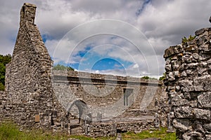 A view alongside one wall of the abanoned ruins of Killone Abbey that was built in 1190 and sits on the banks of the Killone Lake