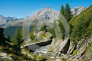 View of alpine pathway and little stream in Valle Aurina, Italy