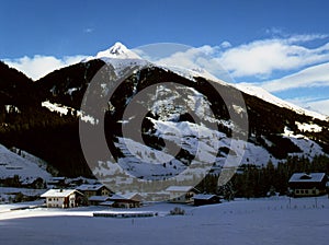 view of the alpine village on the background of mountain peaks