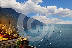 The view of Amalfi coast. This is on the south of Italy in Europe. The city stands on cliffs above the sea. There are boats on the