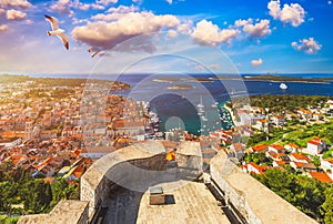 View at amazing archipelago in front of town Hvar, Croatia with seagull's flying over the city. Harbor of old Adriatic island tow
