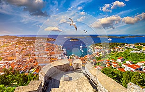View at amazing archipelago in front of town Hvar, Croatia with seagull`s flying over the city. Harbor of old Adriatic island tow photo