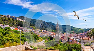 View at amazing archipelago in front of town Hvar, Croatia with seagull`s flying over the city. Harbor of old Adriatic island tow