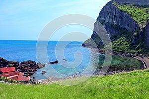 View of amazing volcanic beach and blue sea photo