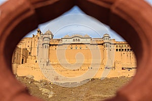View of Amber fort and palace from Kesar Kyari Bagh garden on Maotha Lake. Rajasthan. India