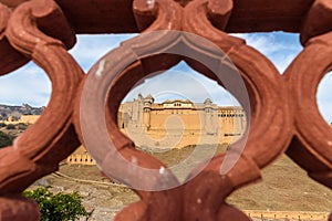 View of Amber fort and palace from Kesar Kyari Bagh garden on Maotha Lake. Rajasthan. India