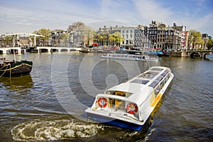 View on Amsterdam and Amstel rive with cruise boats , the Nether photo