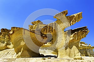 A  view of ancient  limestone cliffs against blue sky