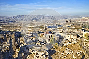 View of ancient Nevsehir cave town and a castle of Uchisar photo