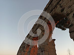 View of ancient roman acqueduct at sunset