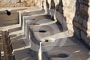 View of the ancient Roman ruins of Ephesus Anatolia, Turkey. Roman public toilet photo