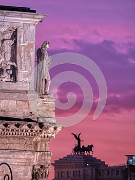 View of the ancient sculpture on the building, sunset, Rome, Italy