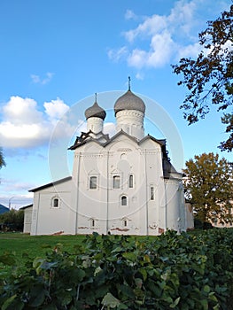 View of the ancient Spaso-Preobrazhensky Monastery with domes, white facade, windows with platbands in the ancient city of Staraya