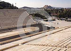 View of the ancient stadium of the first Olympic Games in white marble - Panathenaic Stadium - overlooking the Acropolis and the
