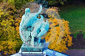 View of the ancient statues man and eagle of stucco and the dome of St. Isaac`s Cathedral Petersburg.