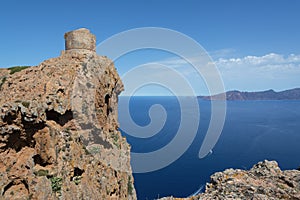 View of an ancient stone tower on a cliff above the sea