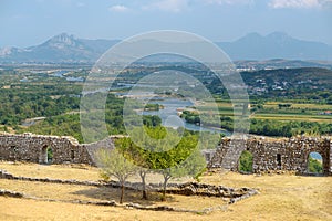 View of ancient stone walls Fortress Rozafa among of amazing mountains valley, Shkodra city, Albania. Famous bastion attracts