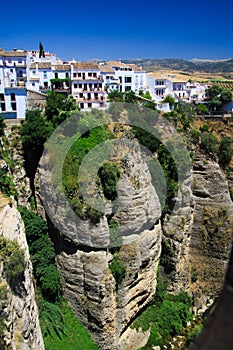 View on ancient village Ronda located precariously close to the edge of a cliff in Andalusia, Spain